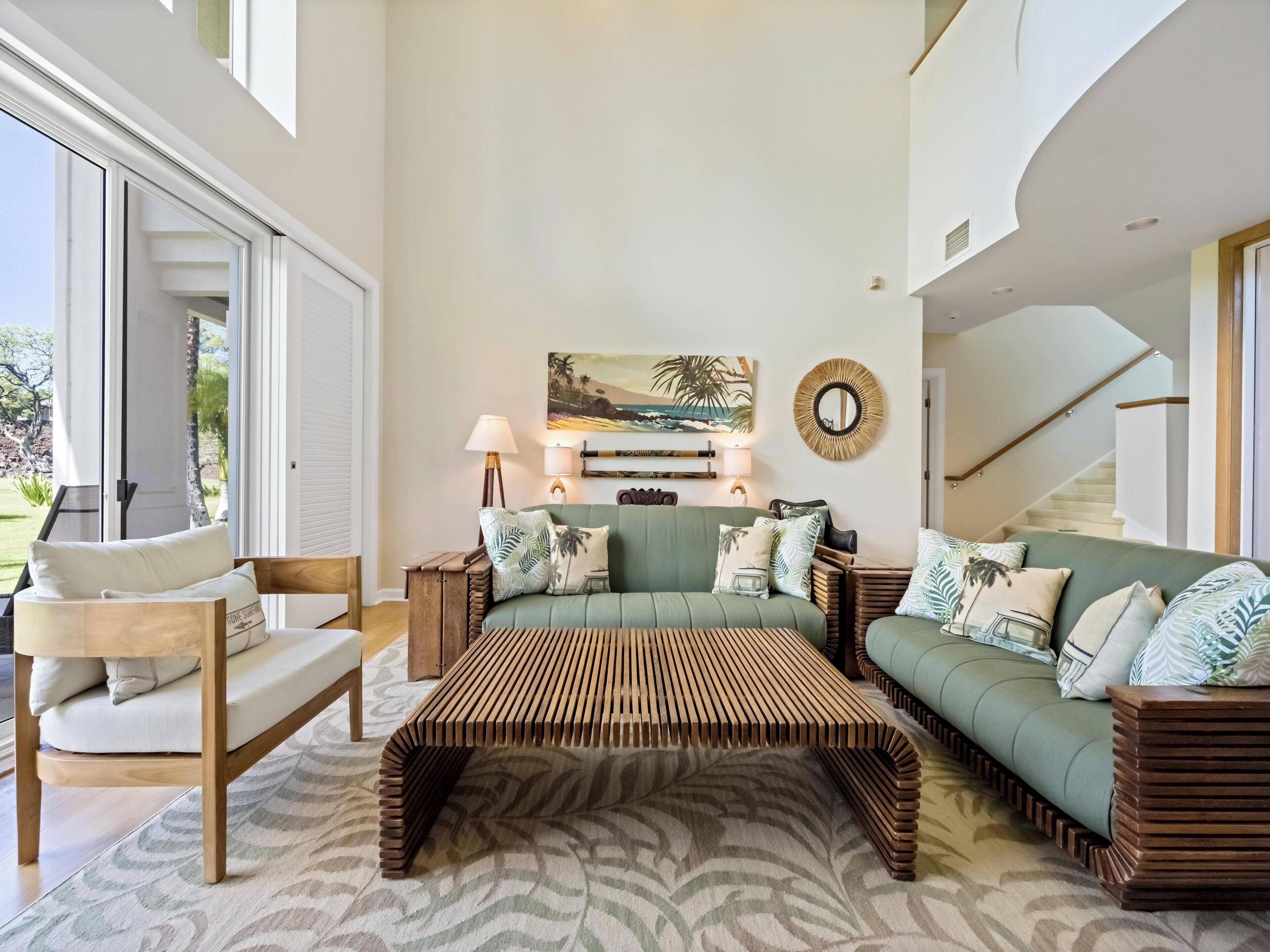 A modern living room with a green sofa, wooden coffee table, and a patterned rug.