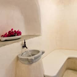 Bathroom features a stone sink and bathtub.