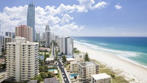 A coastal cityscape with high-rise buildings, a beach, and a clear sky. - Breakfree Acapulco (Surfers Paradise)
