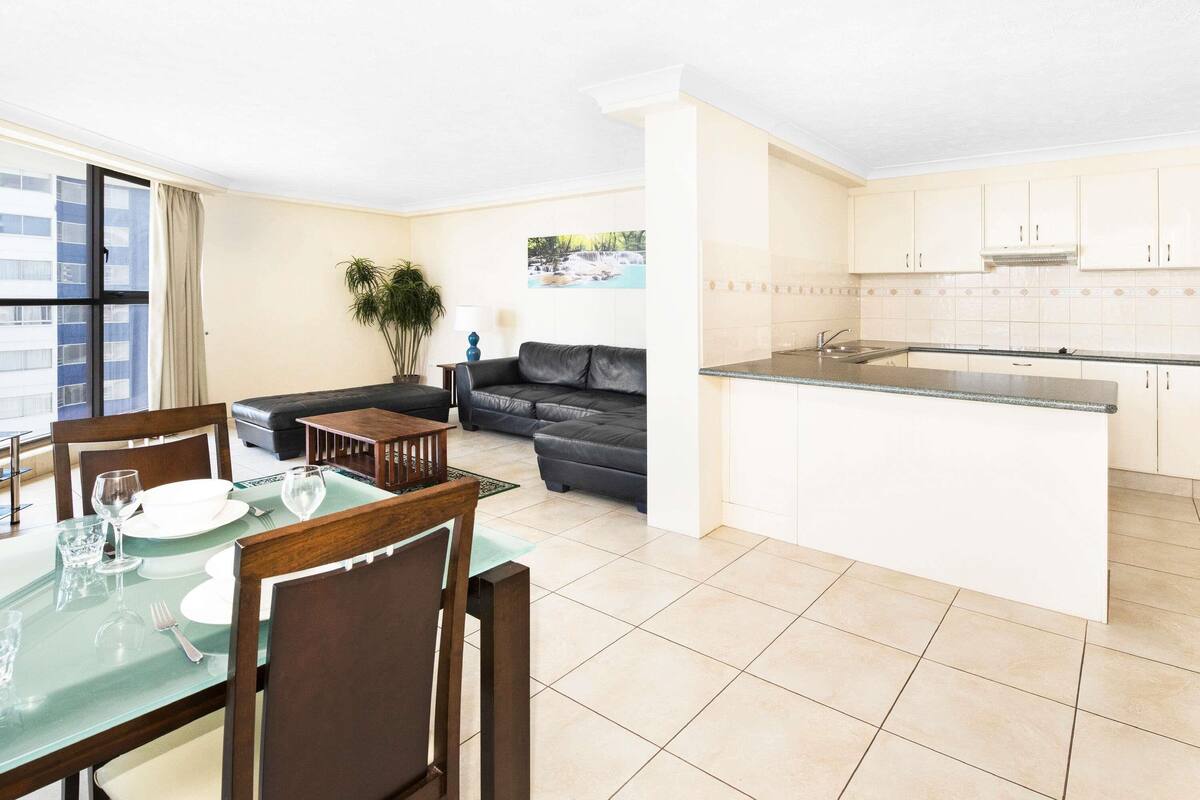 A modern apartment with a dining area, living room, and kitchen.