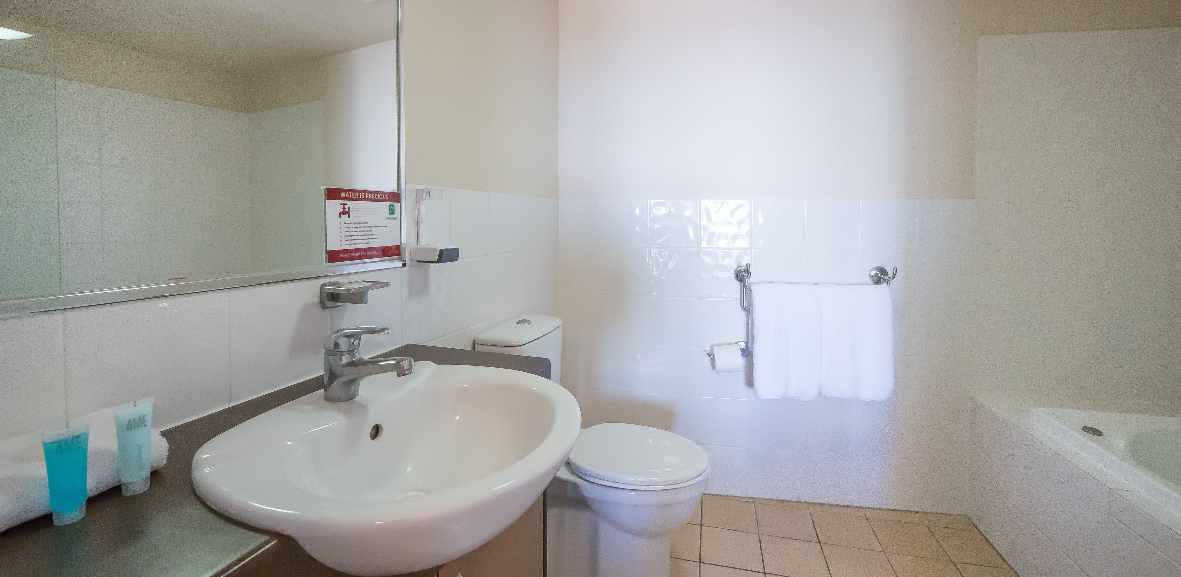 A bathroom with a sink, toilet, and bathtub.