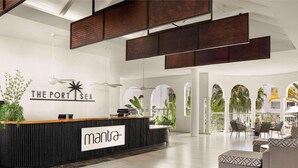 A reception area with a sign reading 'THE PORT SEA' and 'mantra'. - Mantra PortSea (Port Douglas)