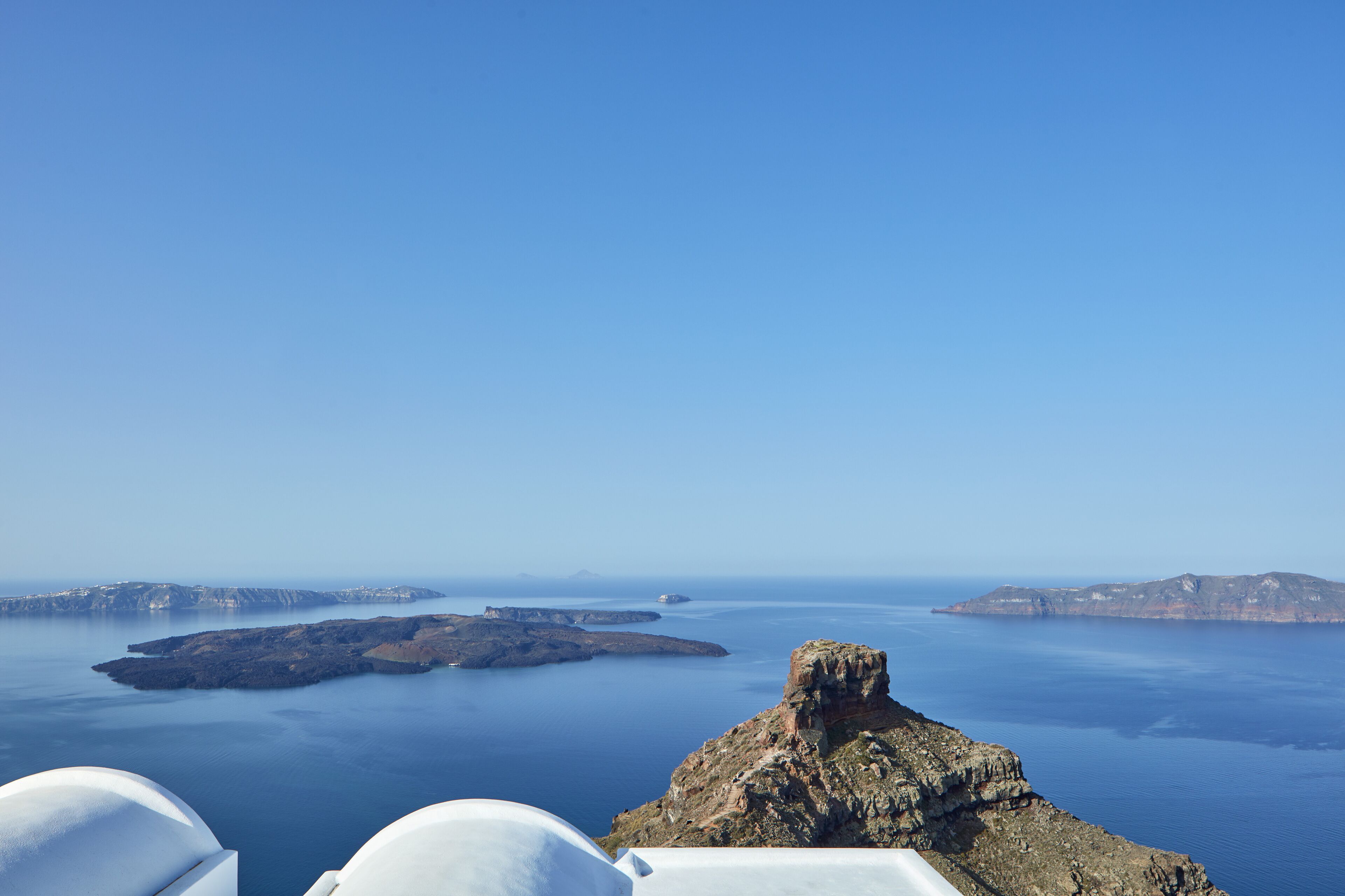 A coastal view with rocky terrain and calm waters.