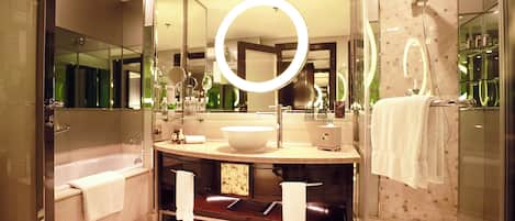 Een moderne badkamer met een grote spiegel, een badkuip en een douche.