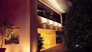 A modern building with a prominent entrance labeled "PROMENADE HOTEL." - PROMENADE HOTEL ZALKA (Zalqa)