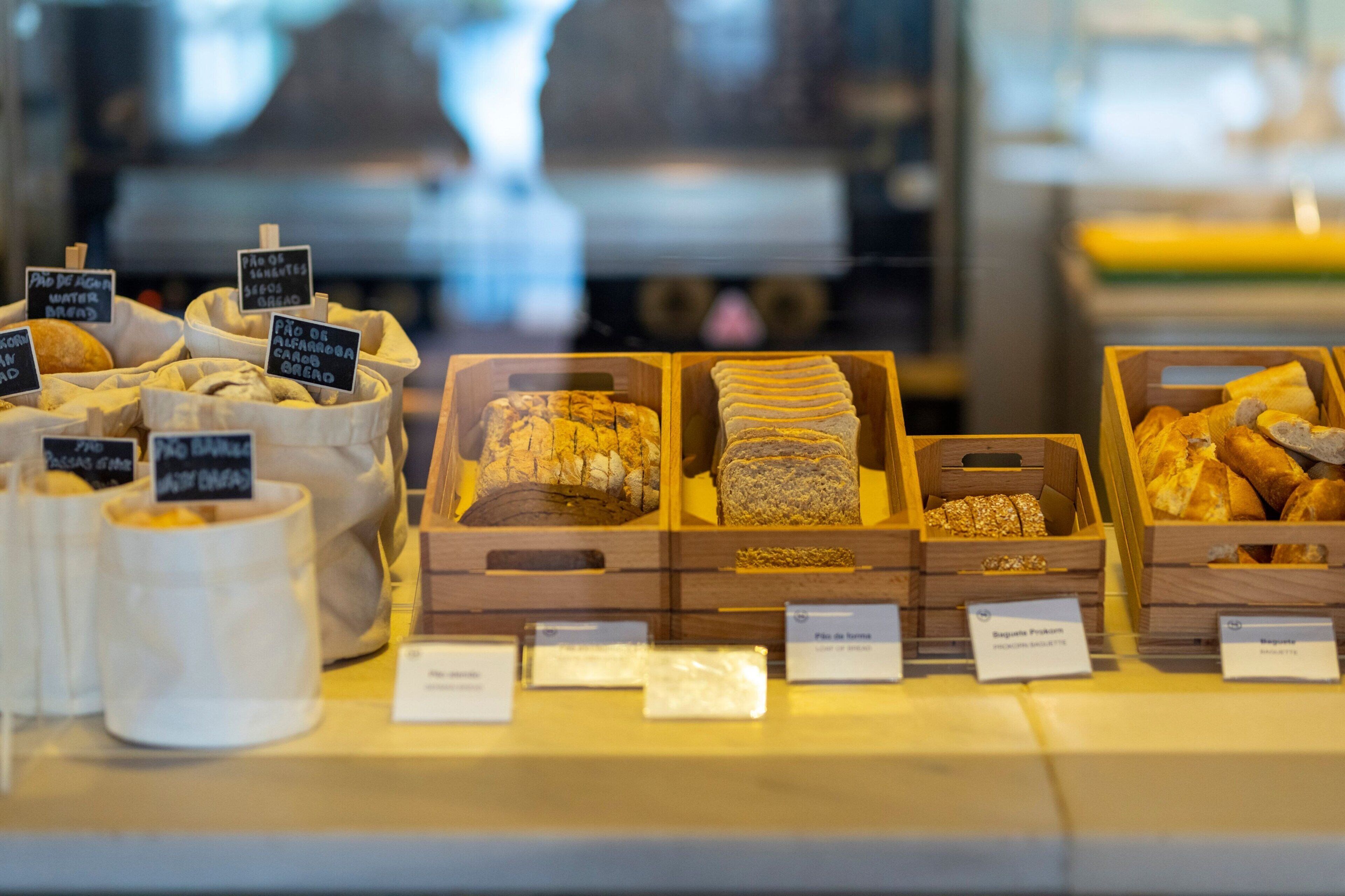 A bakery display with various types of bread and pastries.