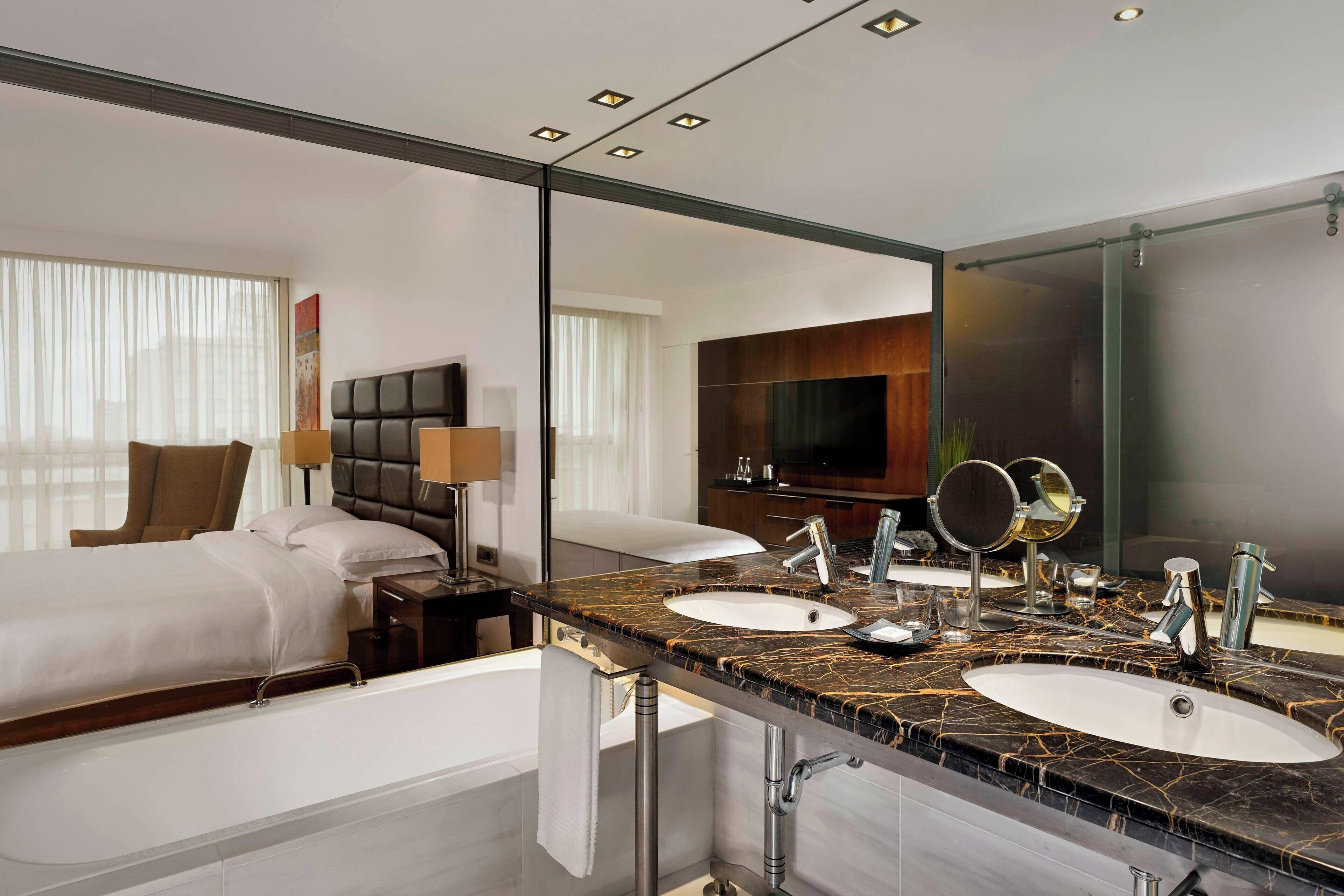 executive suite, 1 king bed | bathroom | combined shower/bathtub, deep-soaking bathtub, rainfall showerhead