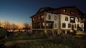 A large, multi-story building with a traditional architectural style, featuring multiple balconies and large windows.