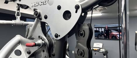 A gym with exercise equipment, including a stationary bike and a treadmill.