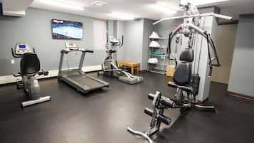 A gym with treadmills, an elliptical, and a weight machine.