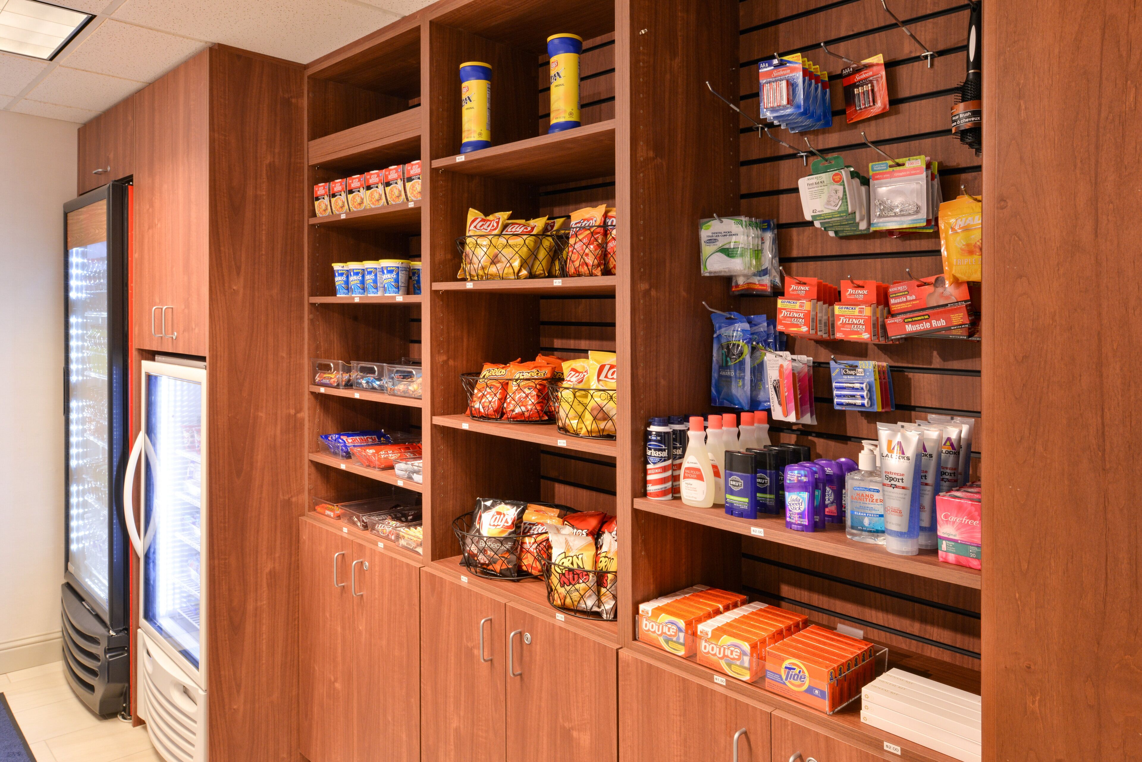 A grocery store with shelves stocked with snacks, beverages, and household items.