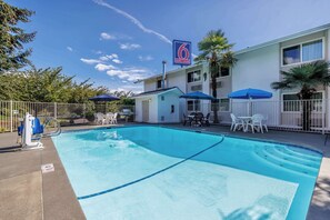 Seasonal outdoor pool, open 9:00 AM to 9:00 PM, pool umbrellas