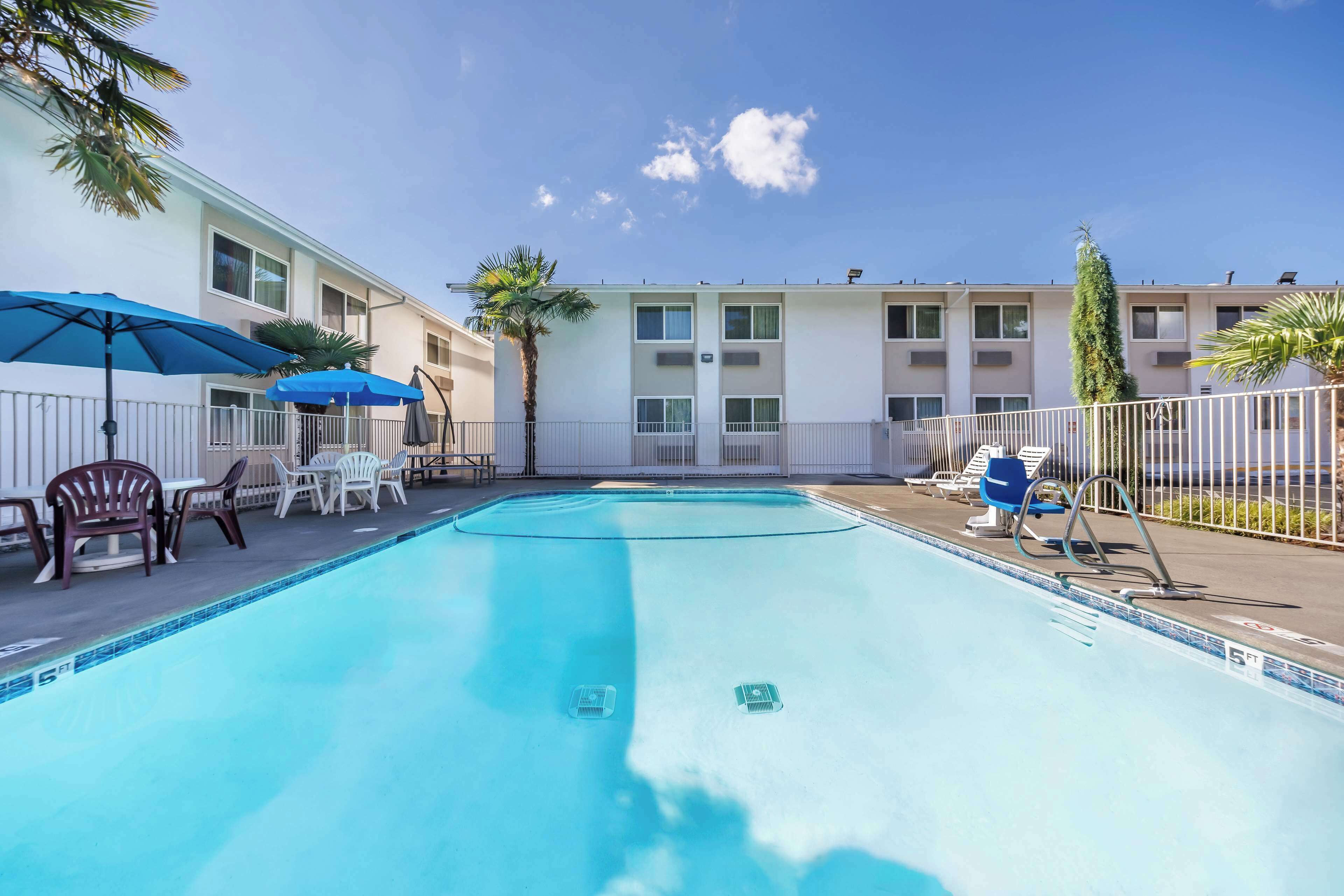 Seasonal outdoor pool, open 9:00 AM to 9:00 PM, pool umbrellas