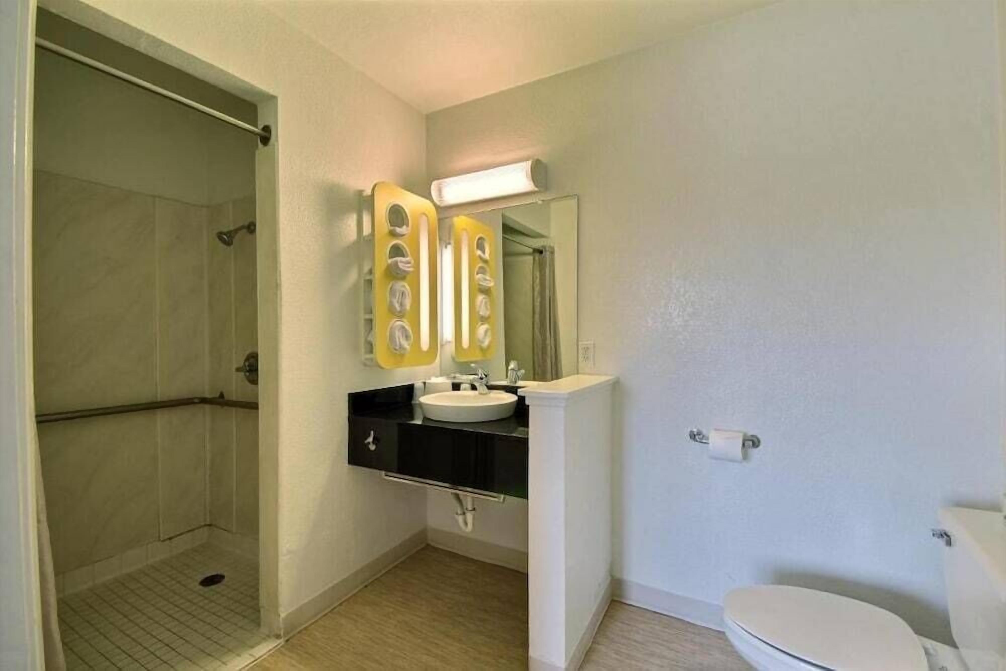 Un bagno con doccia, lavandino e WC.
