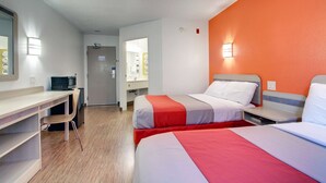 A hotel room with two beds, a desk, a chair, and a microwave. - Motel 6 Springfield, IL (Springfield)