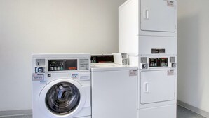 A commercial washer and dryer unit with digital displays and control panels. - Motel 6 Springfield, IL (Springfield)