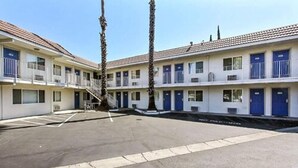 A row of motel buildings with a parking lot in front. - Motel 6 Campbell, CA - San Jose (Campbell)