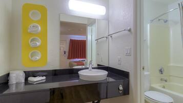 Combined shower/bathtub, towels, soap, toilet paper