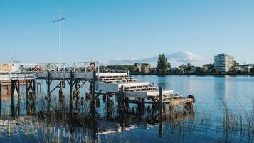 A pier extending into a calm body of water with a cityscape in the background.