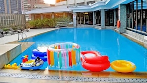 A rooftop pool with inflatable toys and a lifeguard stand. - Zhongshan International Hotel (Zhongshan)
