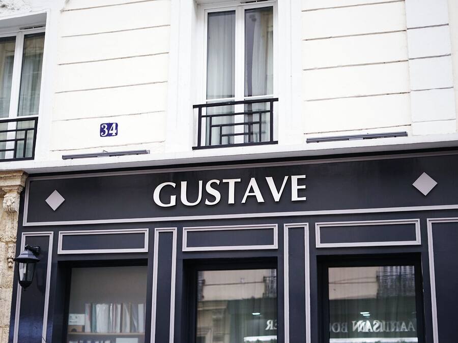 A building with a sign reading 'GUSTAVE' above the entrance.