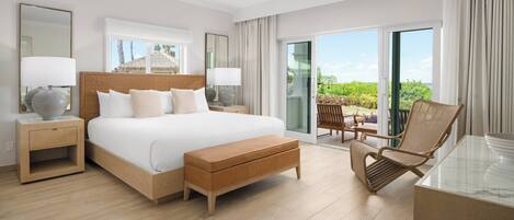 A hotel room with a bed, a nightstand, a chair, a table, and a balcony with a view.