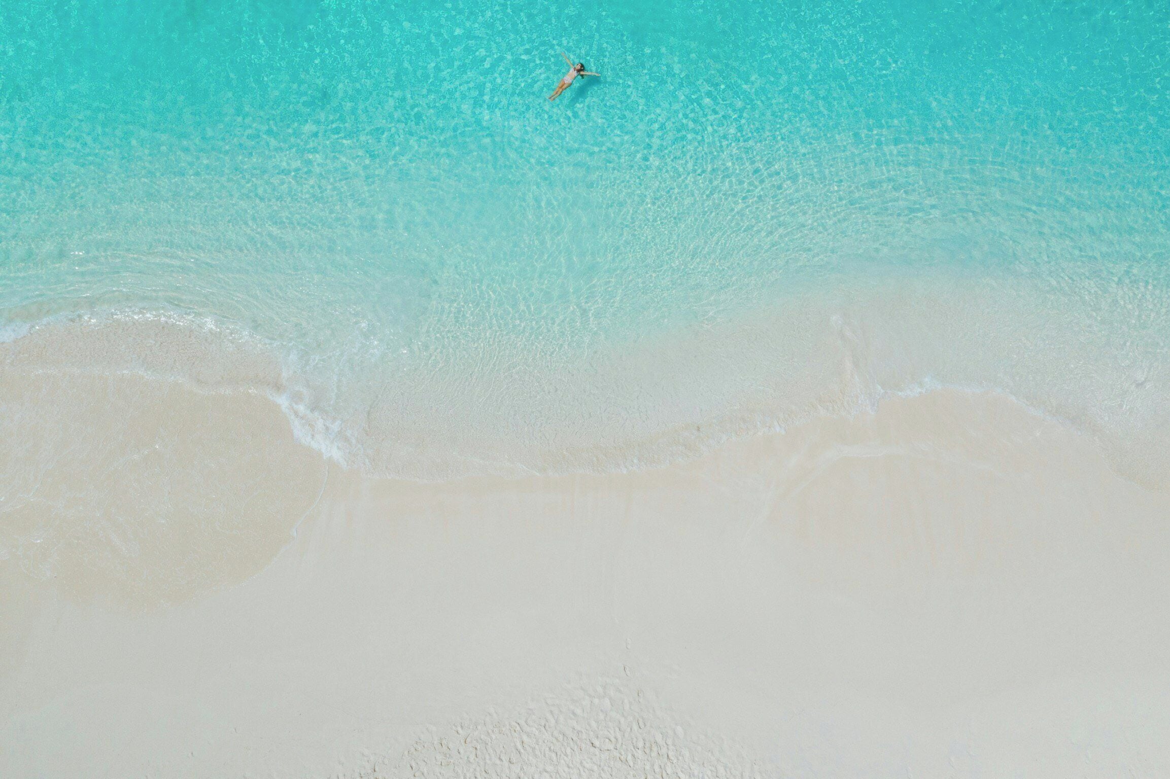 On the beach, white sand, sun loungers, beach umbrellas