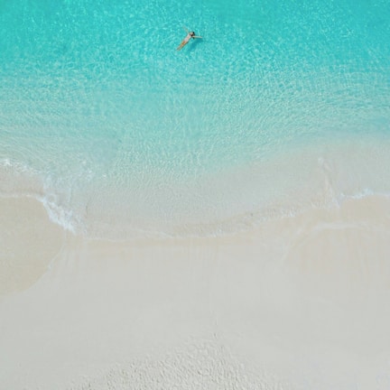 On the beach, white sand, sun loungers, beach umbrellas