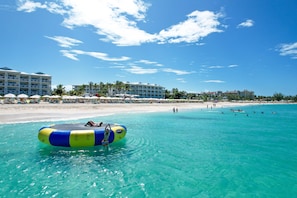 On the beach, white sand, sun loungers, beach umbrellas