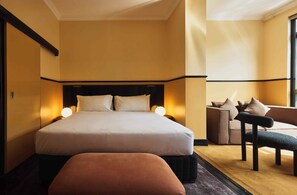 A hotel room with a large bed, a sofa, and a chair. - Hotel Diplomat Sydney (Potts Point)