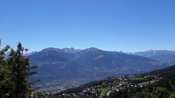A mountainous landscape with a village nestled in the valley.