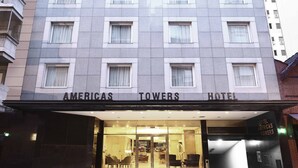 A hotel entrance with a modern facade, multiple windows, and a sign reading "AMERICAS TOWERS HOTEL". - Cyan Americas Towers Hotel (Buenos Aires)