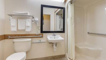 A bathroom with a toilet, sink, and shower.
