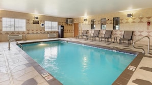 A swimming pool with a tiled edge, a no diving sign, and a row of chairs along the wall. - Best Western Parsons Inn (Parsons)