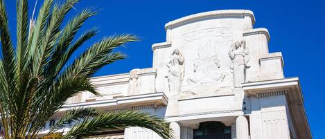 A building with classical architecture, including columns and detailed sculptures.