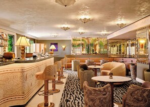 A bar area with a counter, stools, and a patterned carpet. - Hôtel Palais de la Méditerranée In The Unbound Collection By Hyatt (Nice)