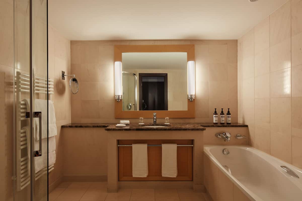 deluxe room, 2 queen beds | bathroom | designer toiletries, hair dryer, bathrobes, slippers