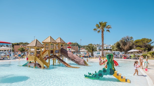 A water park with slides, a play structure, and a pool.