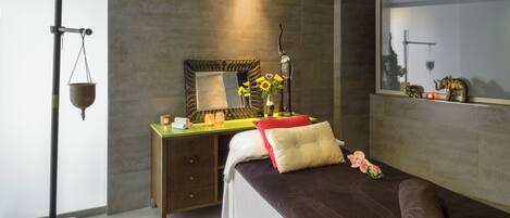 A modern bedroom with a bed, bedside table, and a mirror.