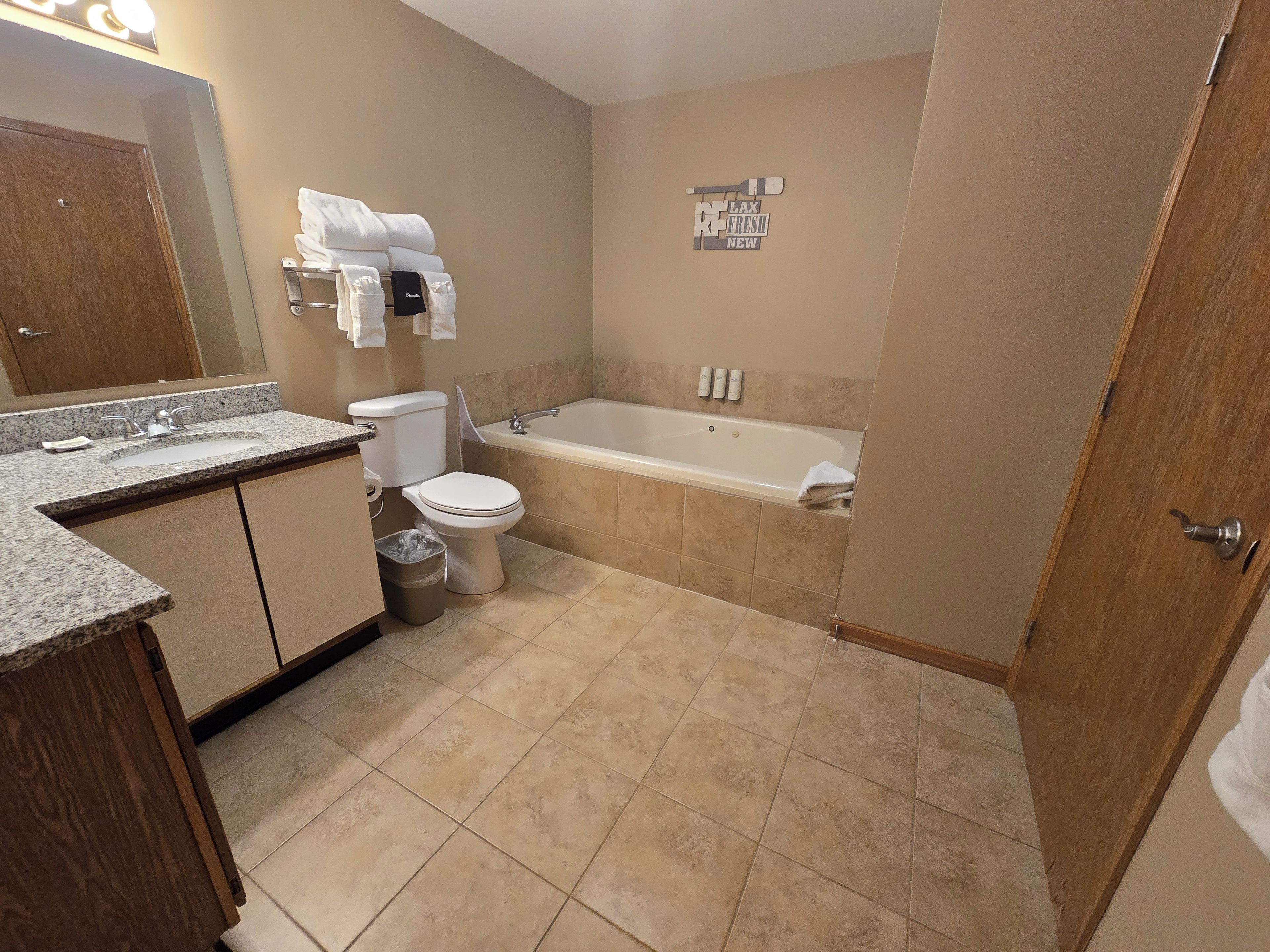 A bathroom with a toilet, sink, and bathtub.