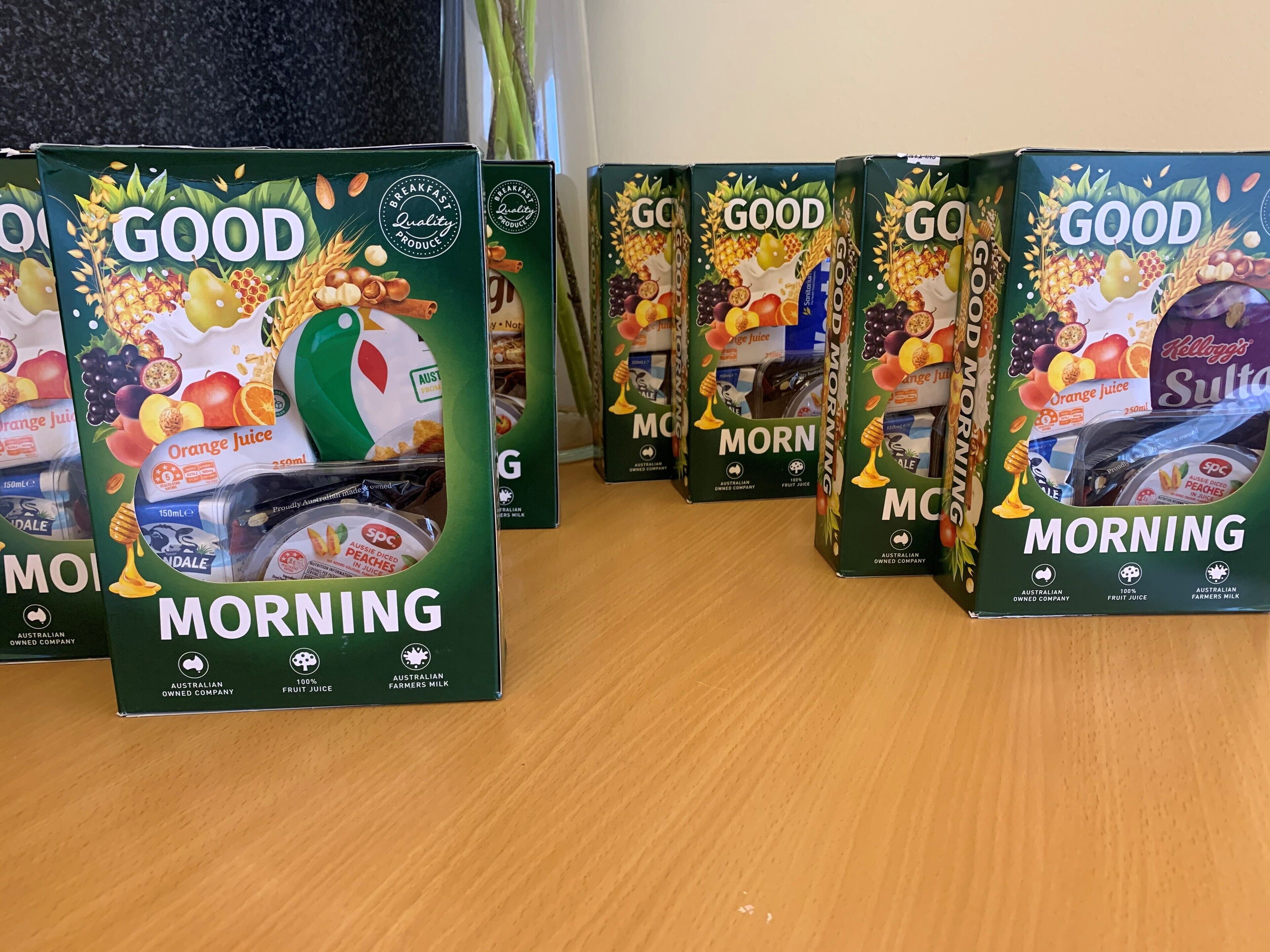 A row of 'Good Morning' juice boxes on a wooden surface.