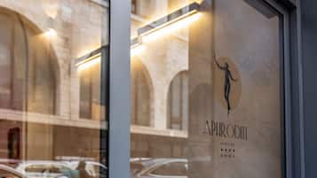 A hotel sign with a silhouette of a person and the name "APRODILE HOTEL ROMA".