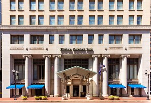 A building with a classical architectural style, featuring a central entrance with a pediment supported by columns, and the name 'Hilton Garden Inn' displayed above. - Hilton Garden Inn Indianapolis Downtown (Indianapolis)