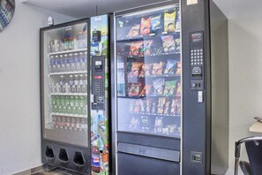 A vending machine with multiple beverage options and snacks.