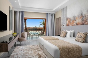 A hotel room with a balcony, a TV, a desk, and a bed with pillows. - Hotel Marrakech Le Sangho Privilege (Marrakech)