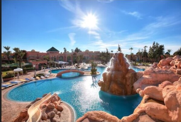 Indoor pool, outdoor pool, pool umbrellas, pool loungers