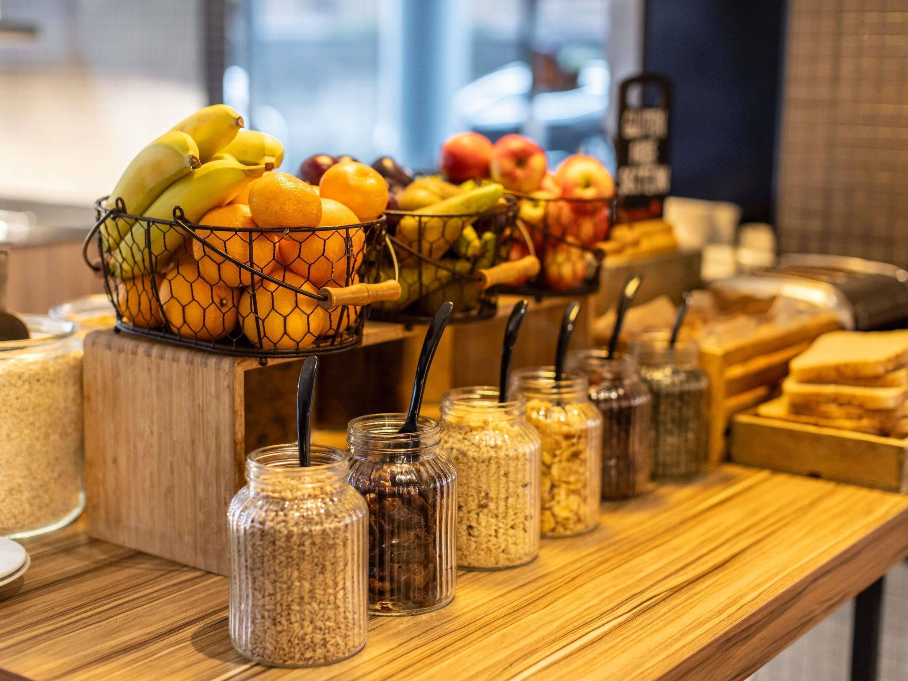 A breakfast buffet with a variety of fruits and cereals.