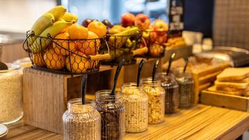 A breakfast buffet with a variety of fruits and cereals.