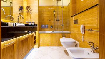 A modern bathroom with a vanity, two sinks, a shower, and a toilet.