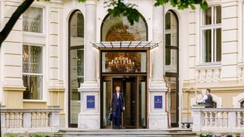 A grand entrance with a large chandelier, a reception desk, and a sign for the Riverside Reception.